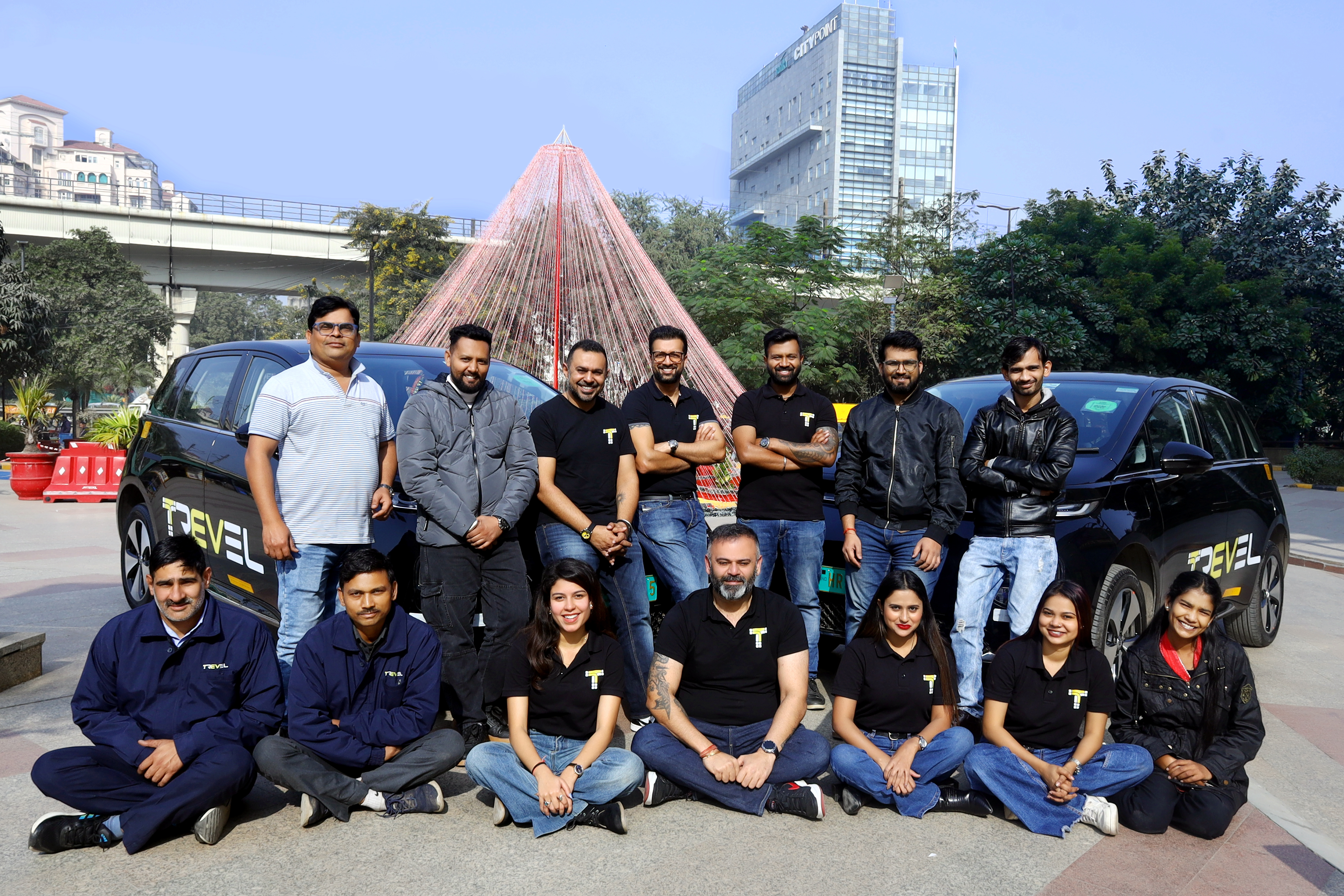 Trevel founders team standing with branded EV cab